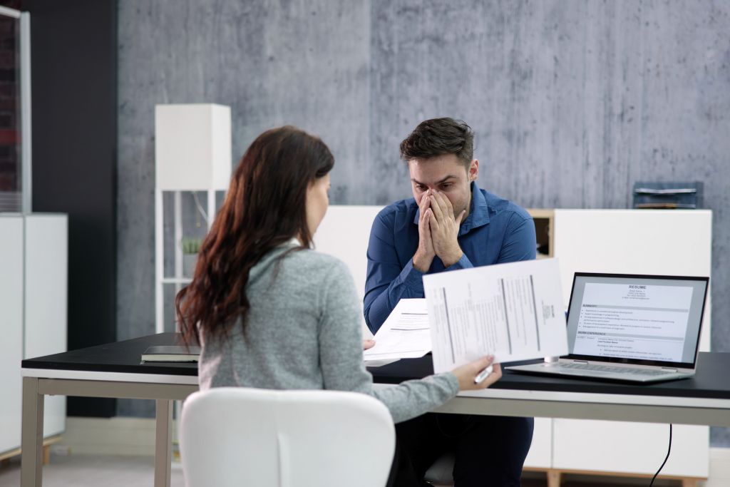 Employee discussing disciplinary documentation with a manager.