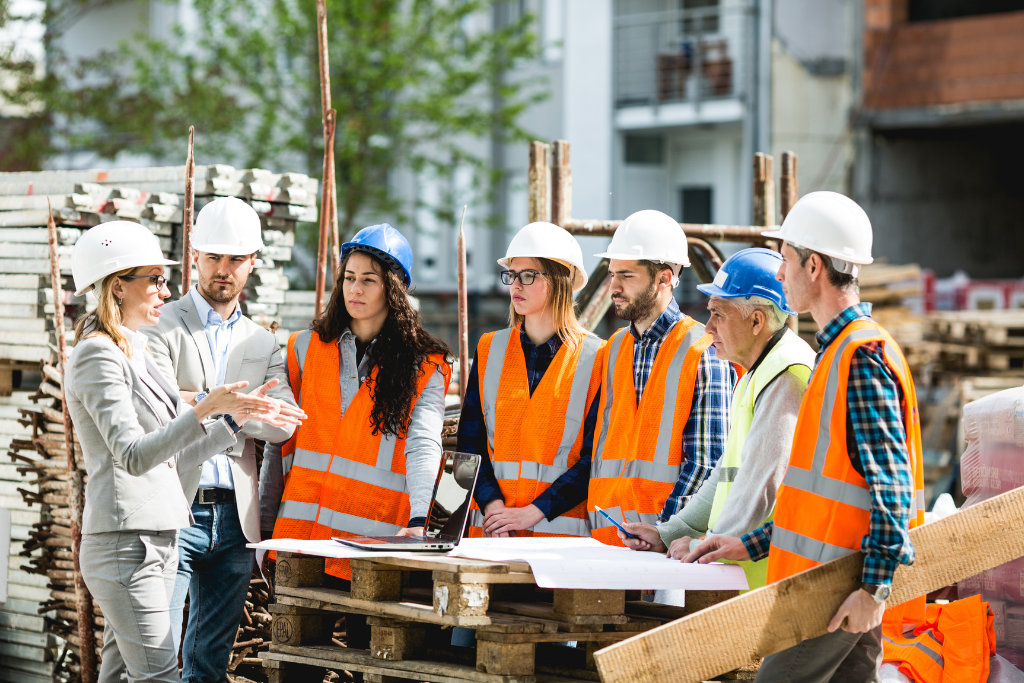 Meridian construction workers and supervisors discussing job site policies and workplace safety programs.