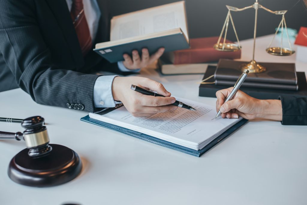 Legal professionals reviewing workplace documentation that supports a company’s defensible drug testing policy and litigation protection.